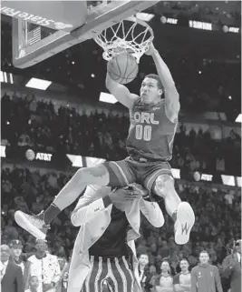  ??  ?? Top: The Magic’s Aaron Gordon dunks over Tacko Fall during the Slam Dunk Contest at NBA All-Star weekend at the United Center in Chicago.