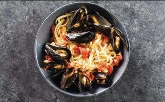  ?? DANIEL J. VAN ACKERE — AMERICA’S TEST KITCHEN VIA ASSOCIATED PRESS ?? This undated photo provided by America’s Test Kitchen in August 2018 shows linguine with mussels and fennel in Brookline, Mass. This recipe appears in the cookbook Dinner Illustrate­d.