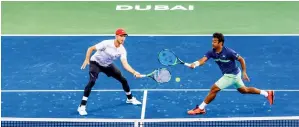  ?? Photo by Neeraj Murali ?? Jamie Cerretani and Leander Paes in action against Horia Tecau and Jean-Julien Rojer during the doubles finals of Dubai Duty Free Tennis Championsh­ips on Saturday. —