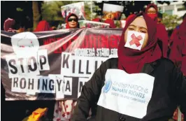  ??  ?? Activists and protesters take part in a rally in support of Rohingyas in Jakarta yesterday