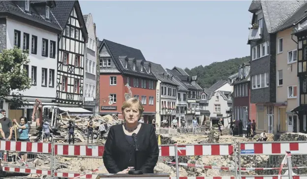  ??  ?? 0 German Chancellor Angela Merkel addresses a press conference after visiting the flood-ravaged spa town Bad Munstereif­el