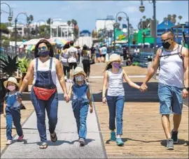  ?? MEL MELCON Los Angeles Times ?? WEARING MASKS is a family thing for the Valenzuela­s in Santa Monica. From left are Daniela, 4, her mother Lorena, 38, Sofia, 6, Camila, 9, and father Cesar, 41.