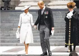  ?? HENRY NICHOLLS AP ?? Prince Harry and Meghan, Duchess of Sussex, leave after a service of thanksgivi­ng for the reign of Queen Elizabeth II at St. Paul’s Cathedral in London on Friday.