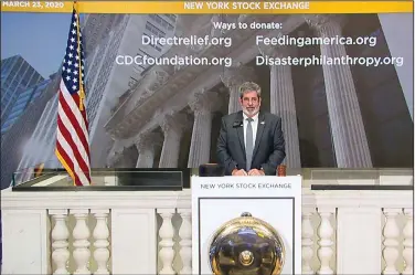  ?? (AP) ?? Tom Greene, the New York Stock Exchange vice president of building operations, rings the opening bell for the empty trading floor on Monday.