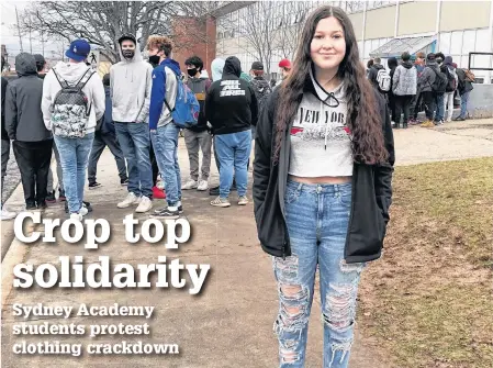  ?? NICOLE SULLIVAN/CAPE BRETON POST ?? Chloe Feltham stands in front of the impromptu that started outside Sydney Academy today during lunch hour in support of the protest against the school’s dress code which she facilitate­d because she believes it sexualized parts of female bodies that aren’t sexual.