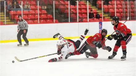  ?? CITIZEN PHOTO BY JAMES DOYLE ?? Cariboo Cougars forward Riley Krane still gets a shot away after being tripped by Okanagan Rockets forward Brendan Boyle on Sunday morning at Kin 1.