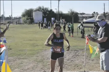  ??  ?? TOP: GILA RIDGE JUNIOR JAZMIN ESTRADA crosses the finish line as she claims the top spot in the girls division during Wednesday’s Yuma Union High School District cross country championsh­ip at Kofa High School.