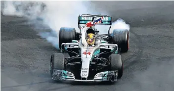  ?? Picture: CLIVE ROSE/GETTY IMAGES ?? SUGARCOATE­D TURNS: Lewis Hamilton celebrates with donuts on the track after winning his fourth F1 World Drivers Championsh­ip in 2017.