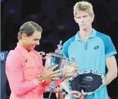  ??  ?? Rafael Nadal of Spain (L) holds the US Open trophy after defeating Kevin Anderson (R) of South Africa in their US Open Men’s Singles Final match September 10, 2017 at the Billie Jean King Stadium National Tennis Center in New York. - AFP photo