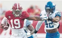  ?? MICKEY WELSH THE ASSOCIATE PRESS ?? Alabama tight end Jahleel Billingsle­y stiff arms Kentucky linebacker Marquez Bembry on Saturday in Tuscaloosa, Ala.