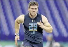  ?? MICHAEL CONROY/THE ASSOCIATED PRESS ?? Wisconsin linebacker T.J. Watt runs a drill at the NFL football scouting combine in Indianapol­is, on Sunday.