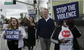  ??  ?? Demonstrat­ors, including Golden State Warriors’ coach Steve Kerr, center, participat­e in a peace march in Oakland, California, on 6 March 2020 to bring attention to the success of gun violence reduction programs. Photograph: Ben Margot/AP