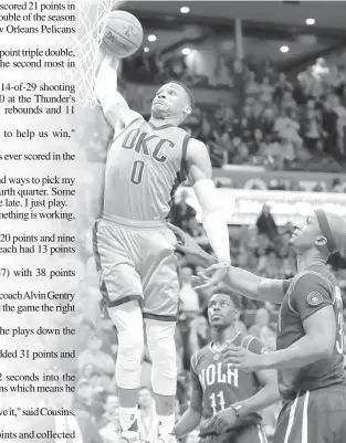  ?? ASSOCIATED PRESS ?? Oklahoma City Thunder guard Russell Westbrook dunks as New Orleans Pelicans guard Jrue Holiday and forward Dante Cunningham look on during the second half of an NBA basketball game in Oklahoma City. Oklahoma City won 118-110.