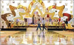  ?? ANTHONY WALLACE/AFP ?? People walk in the casino of the MGM Cotai resort in Macau yesterday.