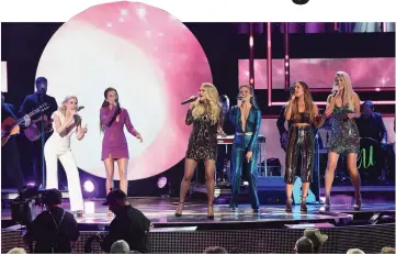  ??  ?? (Left to right) Maddie Marlow and Tae Dye of musical duo Maddie and Tae, Underwood, Hannah Mulholland, Naomi Cooke and Jennifer Wayne of musical group Runaway June perform onstage during the 2018 CMT Artistes of The Year at Schermerho­rn Symphony Center last Wednesday in Nashville, Tennessee. (Right) Honorees Fairchild (left) and Schlapman of Little Big Town accept an award onstage. (Below left to right) Scott, Sheryl Crow, Underwood and Ballerini accept their awards onstage. — AFP photos