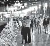  ?? AFP FILE ?? People pay tribute to the victims of the truck attack at the Promenade des Anglais in Nice.