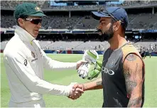  ??  ?? Rival captains Tim Paine, left, and Virat Kohli exchanged several barbs during the test but were happy to shake hands afterwards.