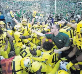  ?? Thomas Boyd ?? The Associated Press Oregon running back CJ Verdell (34), reaches out to a fan after scoring the winning touchdown in overtime to beat Washington 30-27 Saturday in Eugene, Ore.