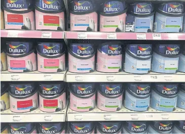  ?? REUTERS ?? Cans of Dulux paint, an Akzo Nobel brand, are seen on the shelves of a hardware store near Manchester, Britain.