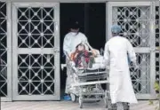  ?? ANI ?? A patient suffering from Covid-19 patient arrives at LNJP Hospital in New Delhi on Thursday.