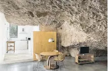  ??  ?? One cave was refurbishe­d into a modern rural house by architects from UMMOestudi­o. The cave is available to rent.