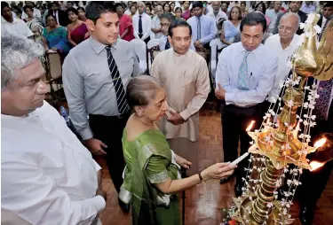  ??  ?? Mrs. Leela Bibile, wife of Prof. Senaka Bibile, lighting the traditiona­l oil lamp to launch the proceeding­s of the Commemorat­ion Festival on Friday. Pix by M. A. Pushpa Kumara