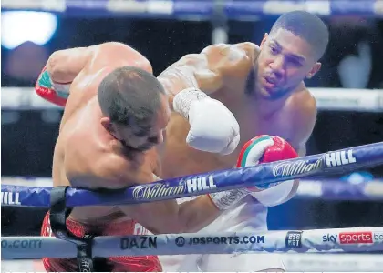  ?? Photo / AP ?? Kubrat Pulev (left) was outclassed by Anthony Joshua in London yesterday, knocked down three times.