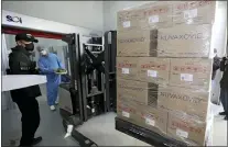  ?? KIM HYUN-TAE — YONHAP VIA AP, FILE ?? A worker moves boxes carrying Novavax’s COVID-19 vaccine at SK Bioscience Co. in Andong, South Korea, on Feb. 9, 2022. Before the pandemic, Novavax was a small American company that had never brought any vaccine to market. Its shots have proven highly effective, but it is relying heavily on other companies to make them.