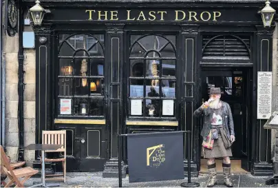  ?? PHOTO: GETTY IMAGES ?? Making the most of it . . . Charles Douglas Barr enjoys a pint outside The Last Drop pub in the Grassmarke­t yesterday in Edinburgh. Scottish First Minister Nicola Sturgeon announced that pubs and restaurant­s across the country’s central belt, including Edinburgh and Glasgow, will close from 6am Saturday NZ time until at least October 25. In other parts of Scotland they can remain open but only serve alcohol outdoors. The new measures come as the country reported more than 1000 new Covid19 cases in a single day. Similar restrictio­ns are expected to be introduced soon in parts of England.