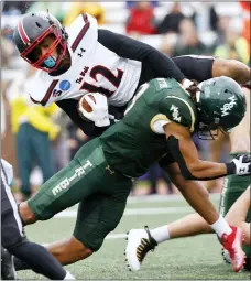  ?? DANIEL SANGJIB — MIN RICHMOND TIMES-DISPATCH VIA AP ?? Gardner-Webb quarterbac­k Glenn Rice is stopped by William & Mary’s Caylin Newton during the first half of an FCS playoffs game at The College of William and Mary last Saturday.