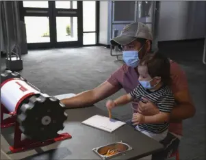  ?? The Sentinel-Record/Grace Brown ?? EXHIBIT EXTENDED: Jose and Aiden Morales, of Memphis, interact with Mid-America Science Museum’s traveling exhibit “Bionic Me” on Thursday. The exhibit was set to close this month, but it has been extended through to January.