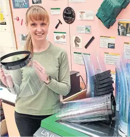  ??  ?? Gemma Crozier, a design and technology teacher at Glenalmond College, shows off one of the face shields produced to help the fight against coronaviru­s.