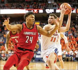 ?? RYAN M. KELLY / GETTY IMAGES ?? Ty Jerome’s (right) 24 points Saturday against Louisville helped No. 2 Virginia clinch the top seed in this week’s ACC Tournament in Charlotte, North Carolina.