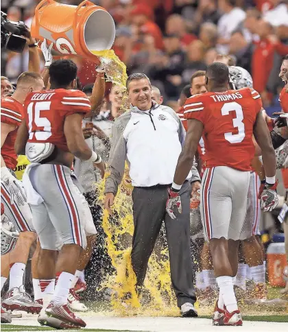  ?? PHOTOS BY JONATHAN QUILTER/COLUMBUS DISPATCH ?? Ohio State coach Urban Meyer was the postgame target of three Gatorade baths in the 2014 college football postseason, each one more satisfying than the last.