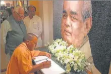 ?? HT PHOTO ?? ▪ CM Yogi Adityanath paying tributes to Vajpayee at his residence in New Delhi. Also seen are Governor Ram Naik and senior minister SN Singh