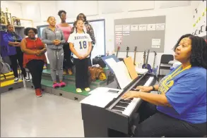  ?? Ned Gerard / Hearst Connecticu­t Media ?? Sheena Graham leads choir practice at Harding High School in Bridgeport on Friday. Graham has been named a finalist for 2019 Connecticu­t Teacher of the Year.