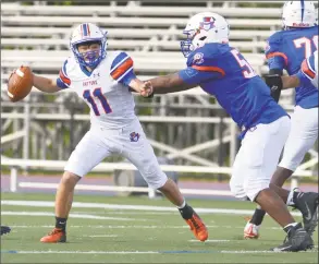  ?? H John Voorhees III / Hearst Connecticu­t Media ?? Quarterbac­k Jackson Ciccone is in the grasp of Kile Jackson in the Danbury spring game Friday.