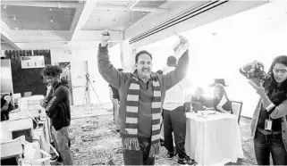  ?? JACOB LANGSTON/ORLANDO SENTINEL ?? Al Borrero celebrates after buying tickets to “Hamilton” on Friday morning at the Dr. Phillips Center for the Performing Arts. Borrero was first in line and arrived last night about 9 p.m. and camped out overnight to purchase the tickets as a surprise for his daughter.