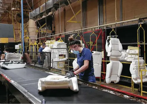  ?? Jerry Lara / Staff photograph­er ?? Workers produce seat padding at Avanzar Interior Technologi­es. Avanzar is a leading supplier for the Toyota truck plant.