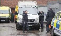  ??  ?? Police officers in black protective suits arrive with new equipment in the cordoned off area around The Mill public house, which had been visited by Sergei Skripal, in Salisbury, Britain, on Wednesday. — Reuters