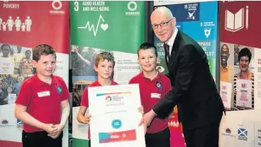  ??  ?? Prize guys John Swinney MSP presents Logierait with its prize last year and the politician praised the school again this year