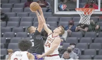  ?? ON GUARD. (AP)* ?? Cleveland Cavaliers forward Lauri Markkanen (24) guards against Sacramento Kings center Alex Len, top left, during the first quarter of an NBA basketball game in Sacramento, Calif., Monday, Jan. 10, 2022.