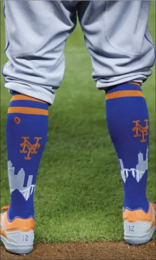  ?? WILFREDO LEE — ASSOCIATED PRESS ?? Mets center fielder Juan Lagares wears socks that include the New York City skyline before the start of a game in Miami in April.