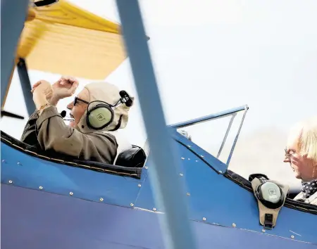  ?? MARTHA ASENCIO-RHINE Tampa Bay Times ?? Christina Wood, 72, gets excited just before takeoff in a World War II biplane at Albert Whitted Airport in St. Petersburg.