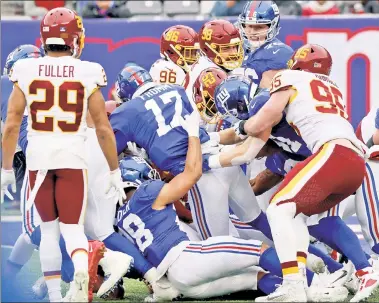  ?? N.Y. Post: Charles Wenzelberg ?? GIVING UP: Facing a second-and-9 from his own 2-yard line, Jake Fromm runs a quarterbac­k sneak out of the Victory Formation. He ran a second one, too, as the Giants didn’t try a handoff to get away from the goal line.