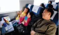  ??  ?? Mr. Zhang, an interior decorator working in Beijing, goes home with his two daughters on the G4907 high-speed train. by Xu Xun