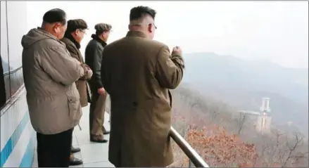  ?? KCNA VIA KNS/AFP ?? This undated picture released by North Korea’s official Korean Central News Agency on March 19 shows North Korean leader Kim Jong-un (right) inspecting a ground jet test of a newly developed high-thrust engine at the Sohae Satellite Launching Ground in...