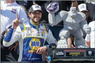  ?? JASON MINTO — THE ASSOCIATED PRESS ?? Chase Elliott gestures next to his trophy after a NASCAR Cup Series auto race at Dover Motor Speedway, Monday, May 2, 2022, in Dover, Del.