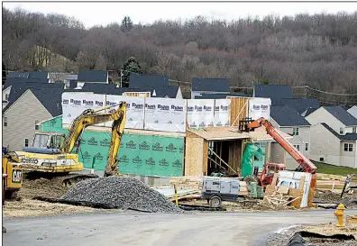  ?? AP file photo ?? Workers construct a home at a developmen­t in Zelienople, Pa., in the spring. Housing starts surged in November, with single-family homes being built at the fastest pace since 2007.