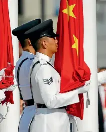  ?? PHOTO: REUTERS ?? China’s and Hong Kong’s flags are raised during a ceremony marking the 20th anniversar­y of the city’s handover from British to Chinese rule.